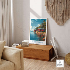 Åland Islands Lakeside Cabin Art Print | Finland Rustic Landscape Poster displayed in a cozy interior setting.