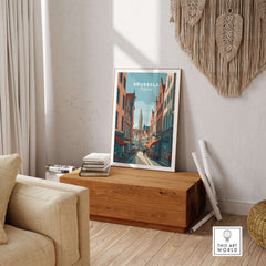 Brussels Belgium Art Print - Grand Place Poster displayed in a cozy living room setting on a wooden table.