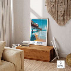 Cocoa Beach Pier Poster - Florida Beach Travel Decor displayed in a stylish living room with coastal vibes.