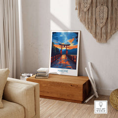 Hakone Wall Art - Japan Travel Poster displayed in a cozy living room setting on a wooden bench.