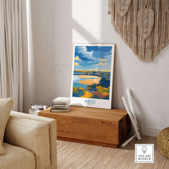 Hayle Estuary Panorama Wall Art - Cornish Travel Poster displayed in a cozy living room setting with natural decor.