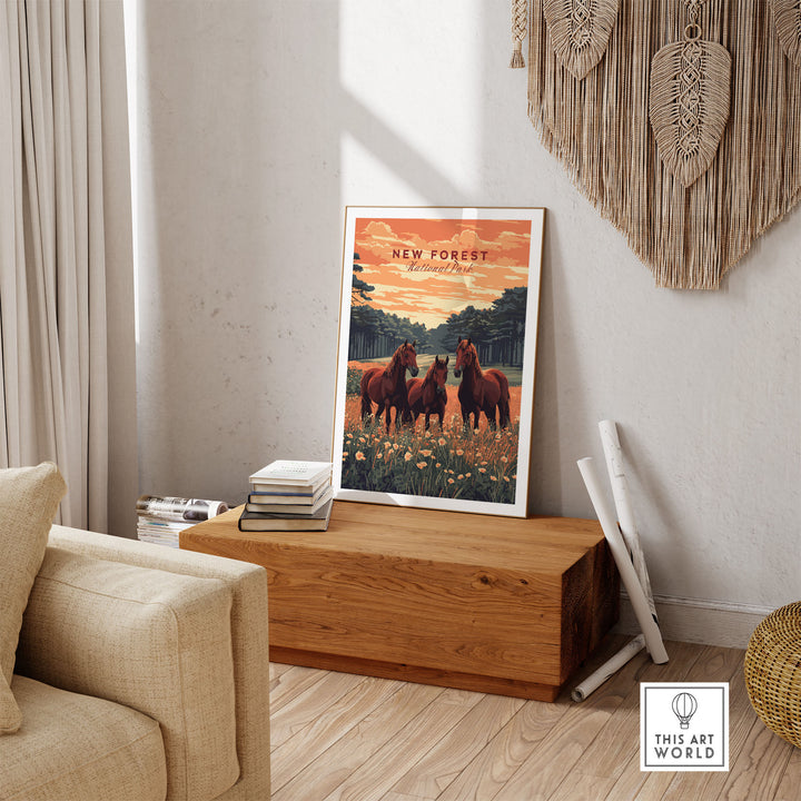 New Forest Print poster with horses in a field, displayed on a wooden table in a cozy living room setting.