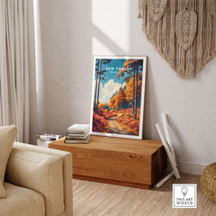 New Forest Travel Poster England displayed in a cozy living room, showcasing vibrant autumnal landscape art.