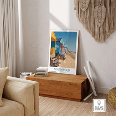 Southwold England Travel Poster displayed in a cozy living room with beach huts and natural decor.