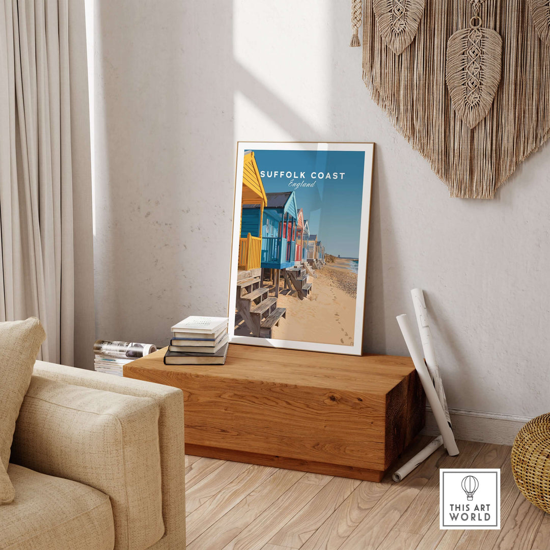 Colorful Suffolk Coast England beach huts poster displayed in a cozy living room setting.