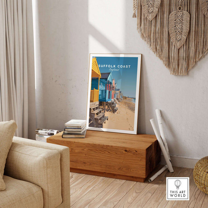 Colorful Suffolk Coast England beach huts poster displayed in a cozy living room setting.
