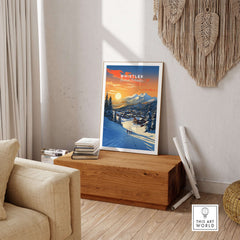Whistler Wall Art Ski Print featuring a stunning sunset over snow-covered mountains, adding charm to any home decor.