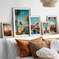 Agadir Travel Poster Print Morocco - Palm Trees displayed among other travel posters in a cozy setting.