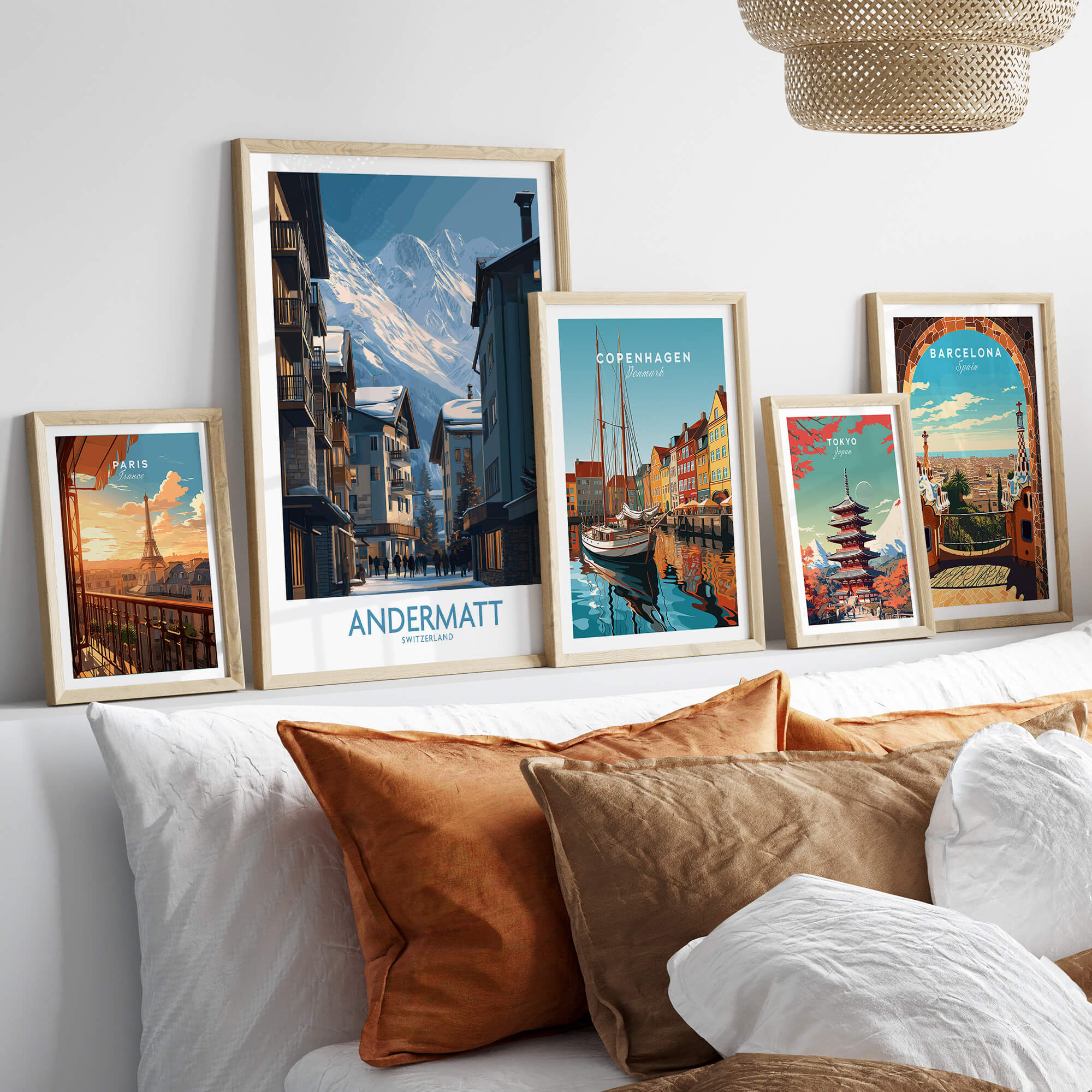 Andermatt Switzerland Wall Art Print displayed among other city prints on a stylish couch with decorative pillows.
