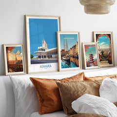 Asmara Eritrea Print – Fiat Tagliero Poster displayed among framed city art prints on a stylish sofa.