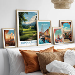 Framed travel art prints of Paris, Balmoral Castle, Copenhagen, Tokyo, and Barcelona above bed
