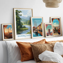 Set of five framed travel posters featuring city skylines and landmarks above a bed