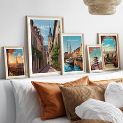Beaune Travel Poster – Burgundy France Wall Art displayed among other travel posters on a contemporary sofa.