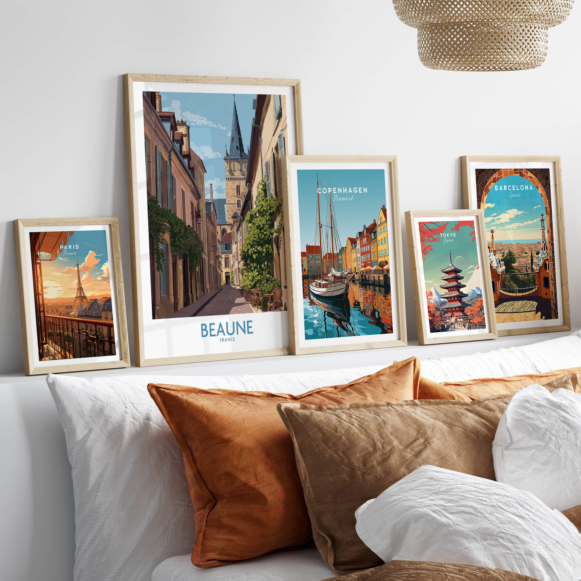 Beaune France Wall Art – Village Print displayed among other city prints on a sofa with colorful pillows.