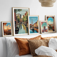 Set of five framed travel and city skyline art prints above bed, modern home decor