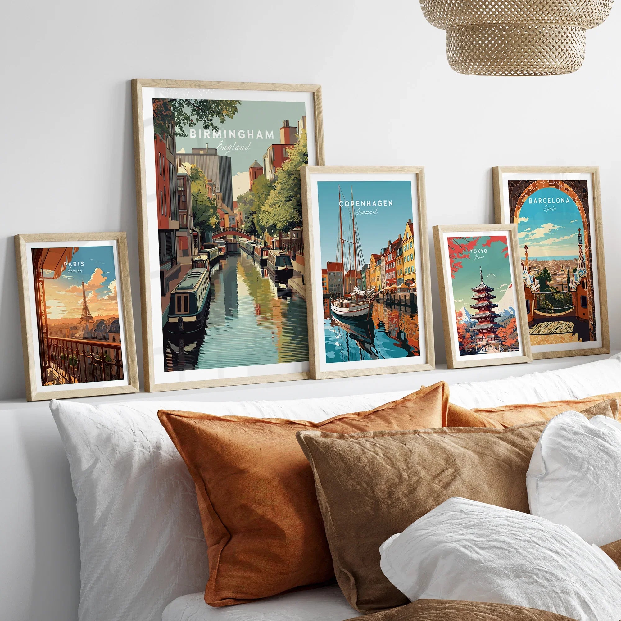 Set of five framed travel and city skyline art prints above bed, modern home decor