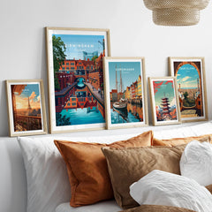 Framed travel posters of Paris, Birmingham, Copenhagen, Tokyo, and Barcelona above a bed