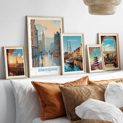 Set of five framed travel posters of cities above bed with natural wood frames