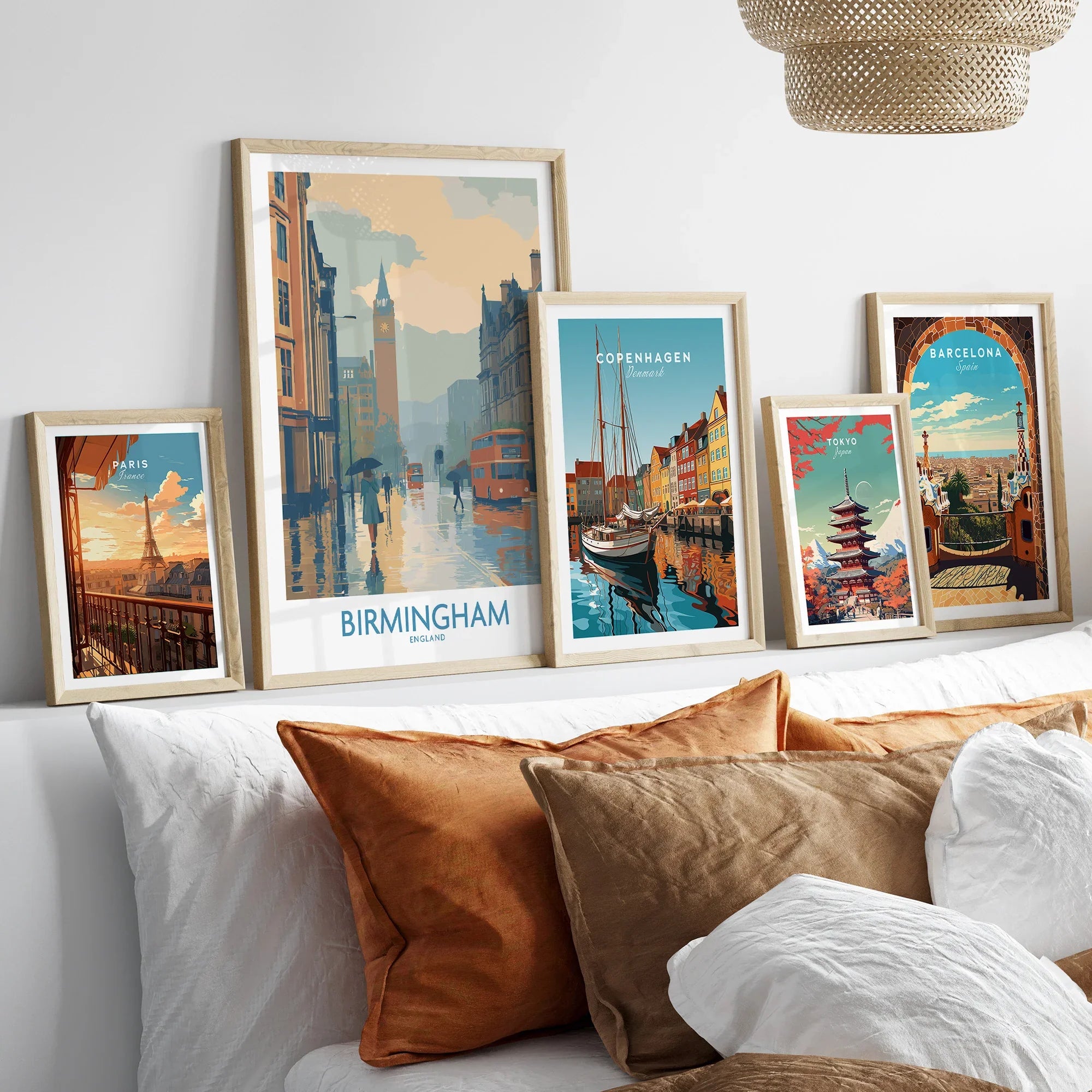 Set of five framed travel posters of cities above bed with natural wood frames