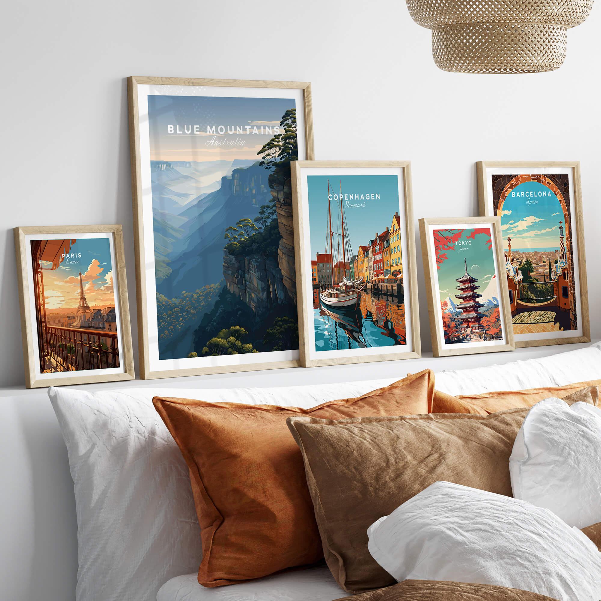 Five framed travel posters above bed, featuring Blue Mountains, Copenhagen, Paris, Tokyo, Barcelona.