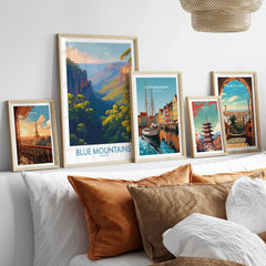 Set of five framed travel posters above bed, featuring Blue Mountains, Paris, Copenhagen, Tokyo, and Barcelona.