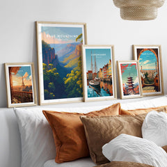 Framed travel posters of Paris, Blue Mountains, Copenhagen, Tokyo, and Barcelona above bed