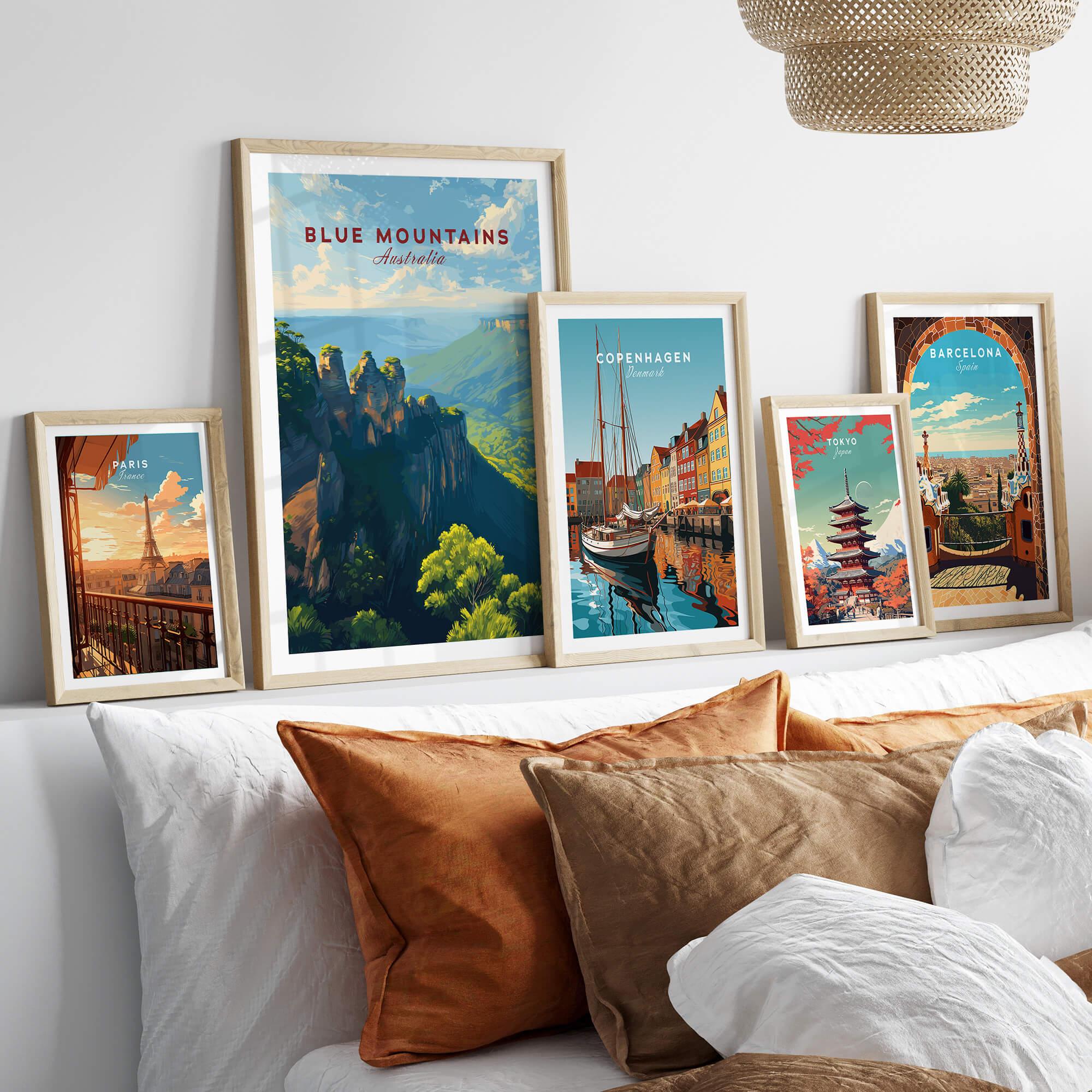 Framed travel posters of Blue Mountains, Paris, Copenhagen, Tokyo, and Barcelona above bed