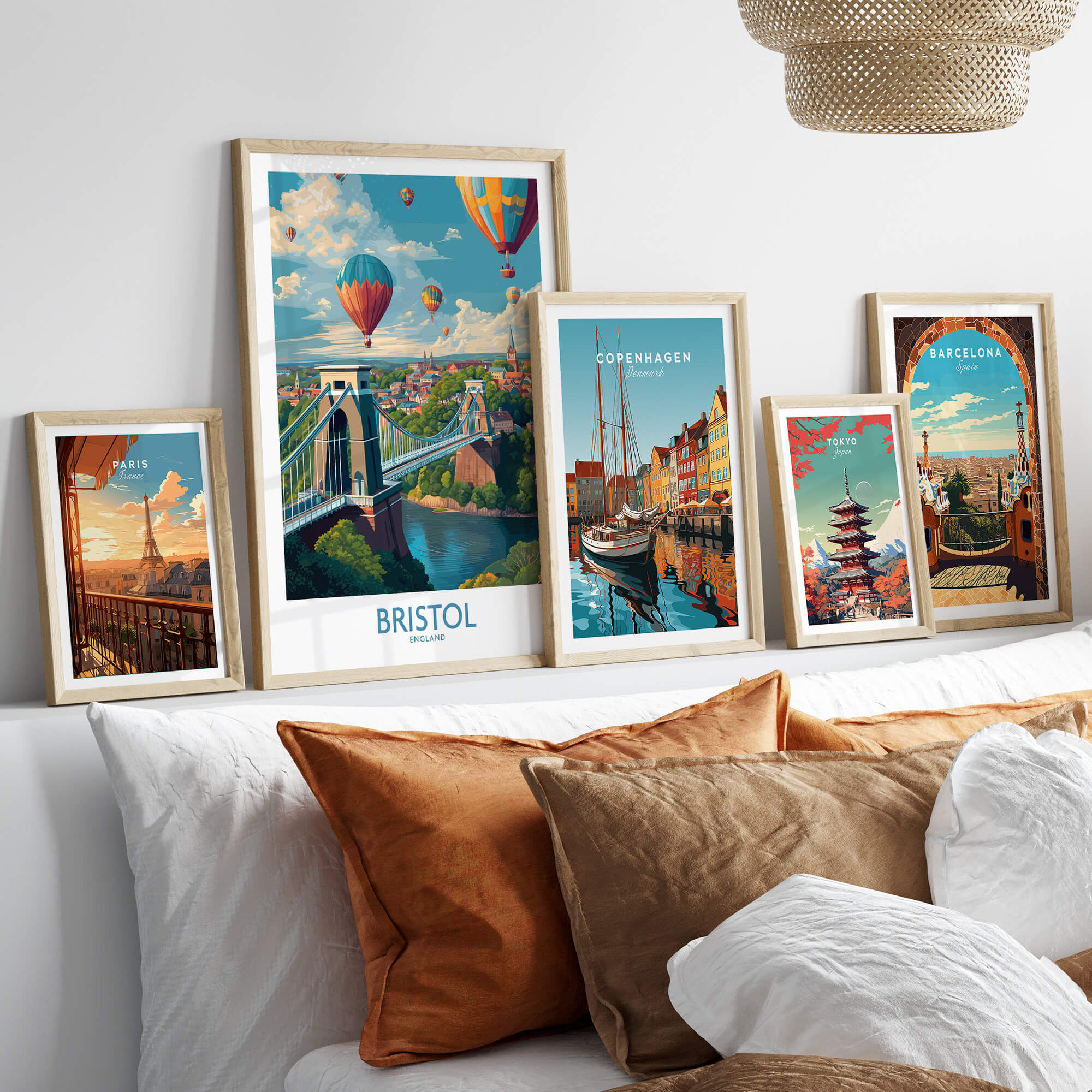 Bristol England Print – Hot Air Balloons Over Historic City Wall Art displayed among framed travel posters on a couch.