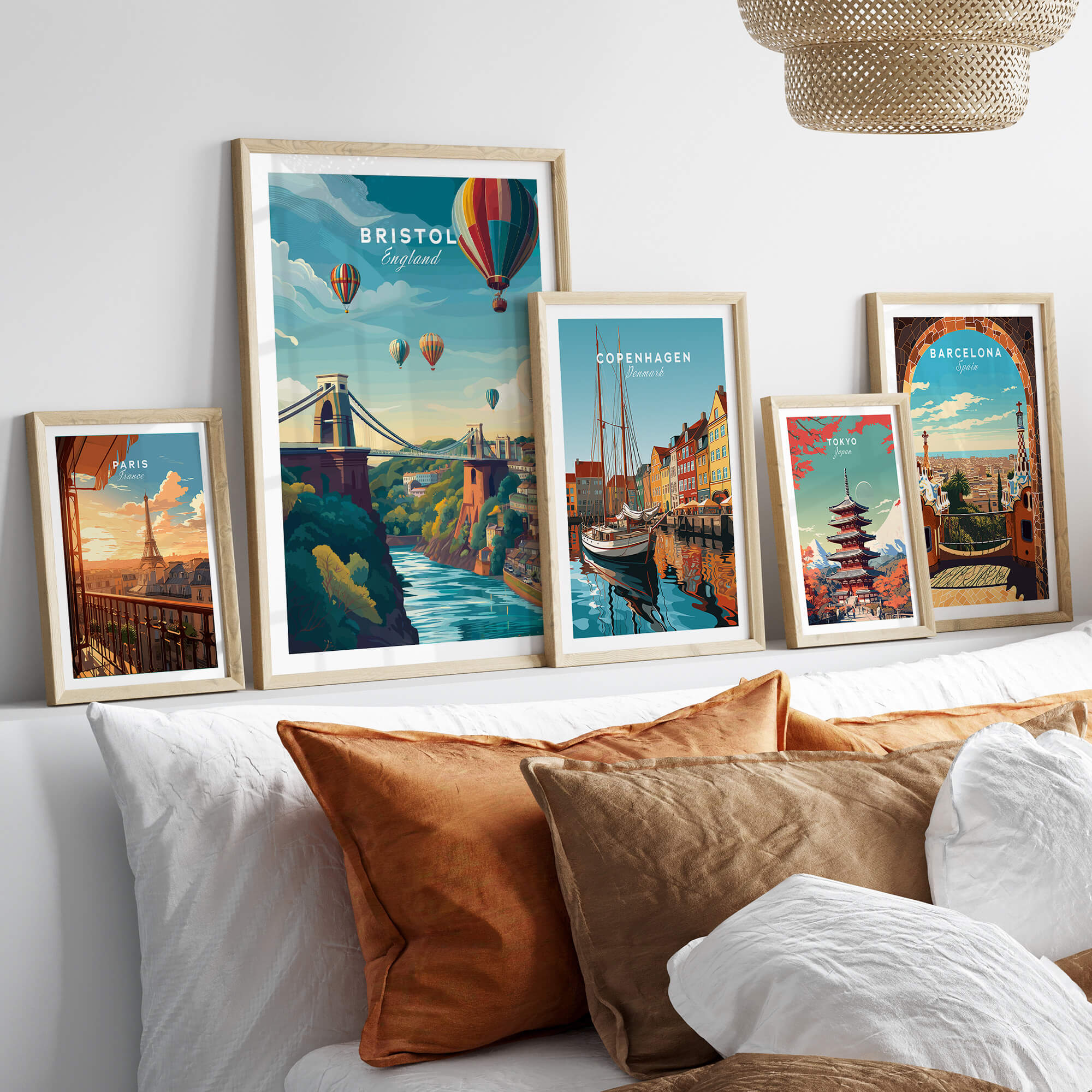 Bristol Art Print - Clifton Bridge Poster framed among other city art prints on a stylish bed.