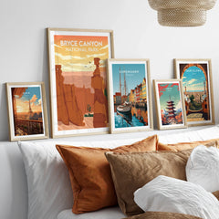 Framed travel posters of Bryce Canyon, Paris, Copenhagen, Tokyo, and Barcelona above bed