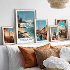 Burleigh Heads Travel Poster - Canvas Print displayed among other travel posters on a modern shelf.