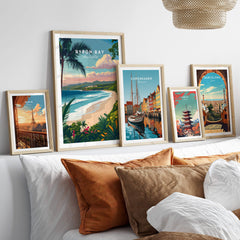 Byron Bay Australia Travel Poster displayed among other travel posters on a modern couch decor.