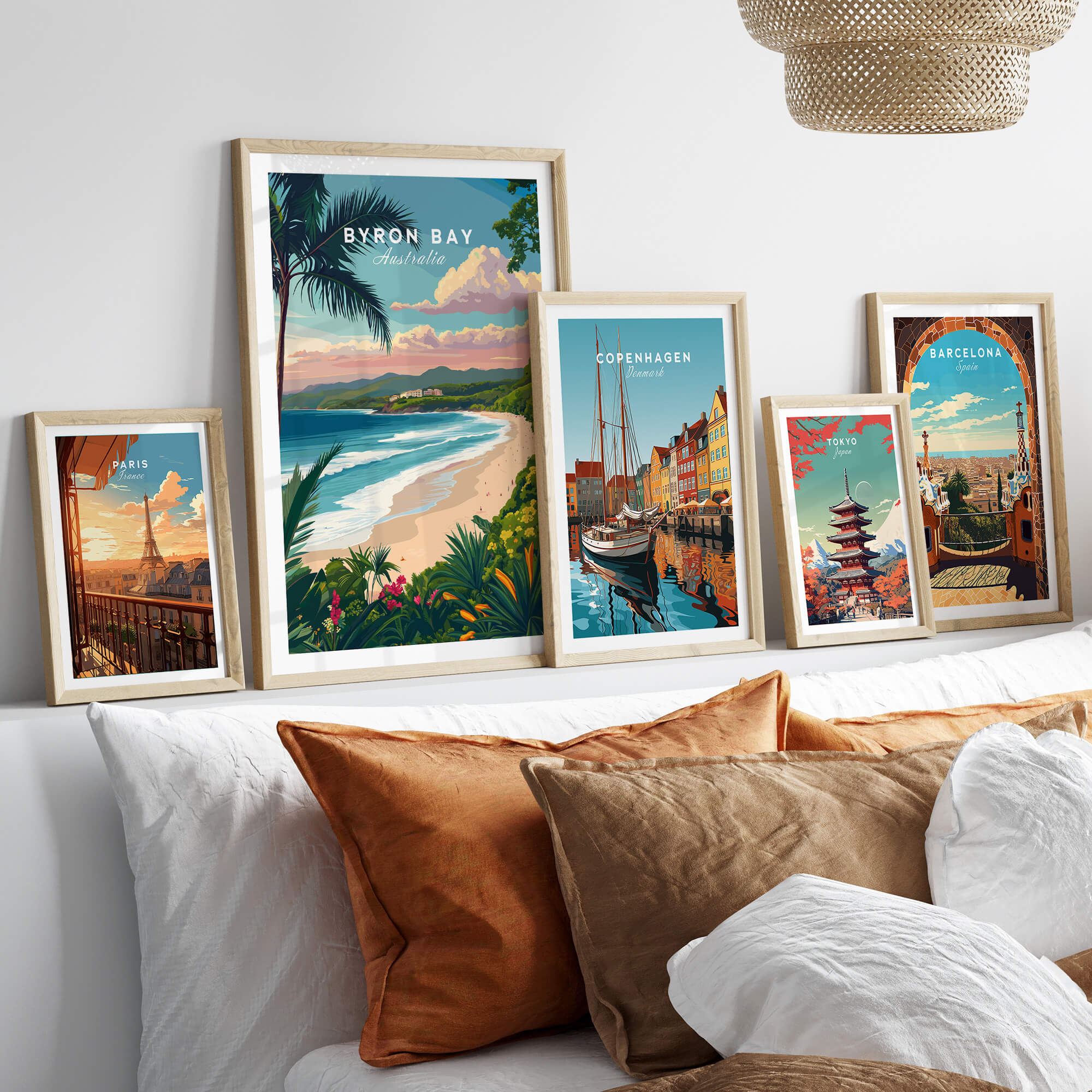 Byron Bay Australia Travel Poster displayed among other travel posters on a modern couch decor.