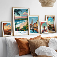 Byron Bay Poster - Australia Wall Art displayed among other travel posters on a stylish living room wall.