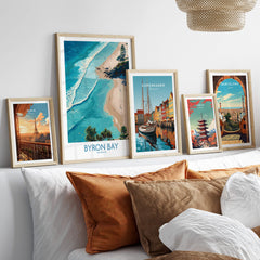 Byron Bay Beach Australia Canvas Art Print displayed among other travel art prints on a stylish sofa.