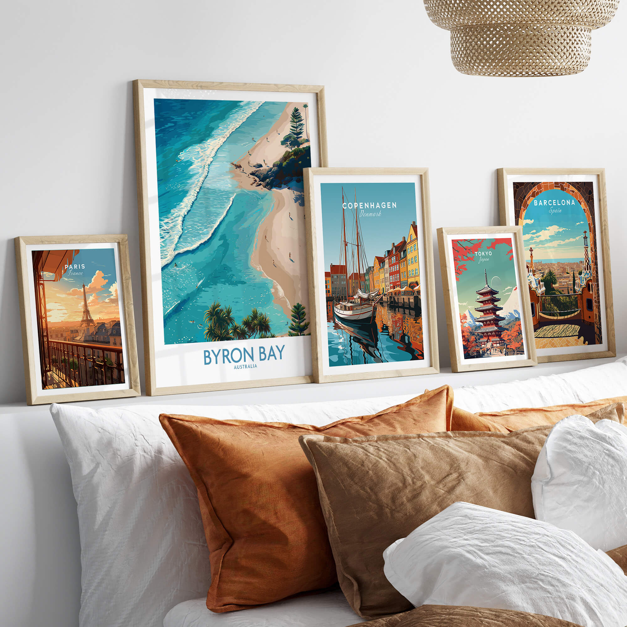 Byron Bay Beach Australia Canvas Art Print displayed among other travel art prints on a stylish sofa.