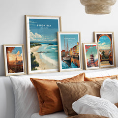 Byron Bay Poster - Canvas Beach Print displayed on a wall with other travel posters, enhancing home decor.