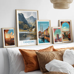 Five framed travel posters of Paris, Wales, Copenhagen, Tokyo, and Barcelona above a bed