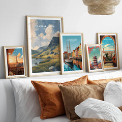 Set of five framed travel art prints above bed, featuring city and landscape posters