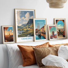 Framed travel posters of Paris, Wales, Copenhagen, Tokyo, and Barcelona above a bed