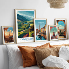 Framed travel posters of Carmel Valley, Paris, Copenhagen, Tokyo, and Barcelona above a bed