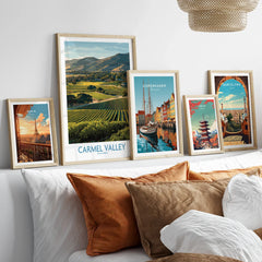 Set of five framed travel art prints above bed, featuring landscapes and city skylines.
