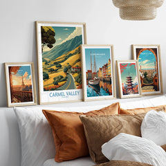 Set of five framed travel posters above a bed, featuring Paris, Carmel Valley, Copenhagen, Tokyo, and Barcelona.