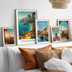 Framed travel posters of Catalina Island, Paris, Copenhagen, Tokyo, and Barcelona above bed