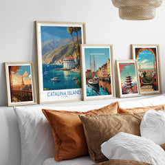 Framed travel poster art prints of Paris, Catalina Island, Copenhagen, Tokyo, and Barcelona above a bed