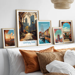 Framed travel art prints of Central Park, Paris, Copenhagen, Tokyo, and Barcelona above bed