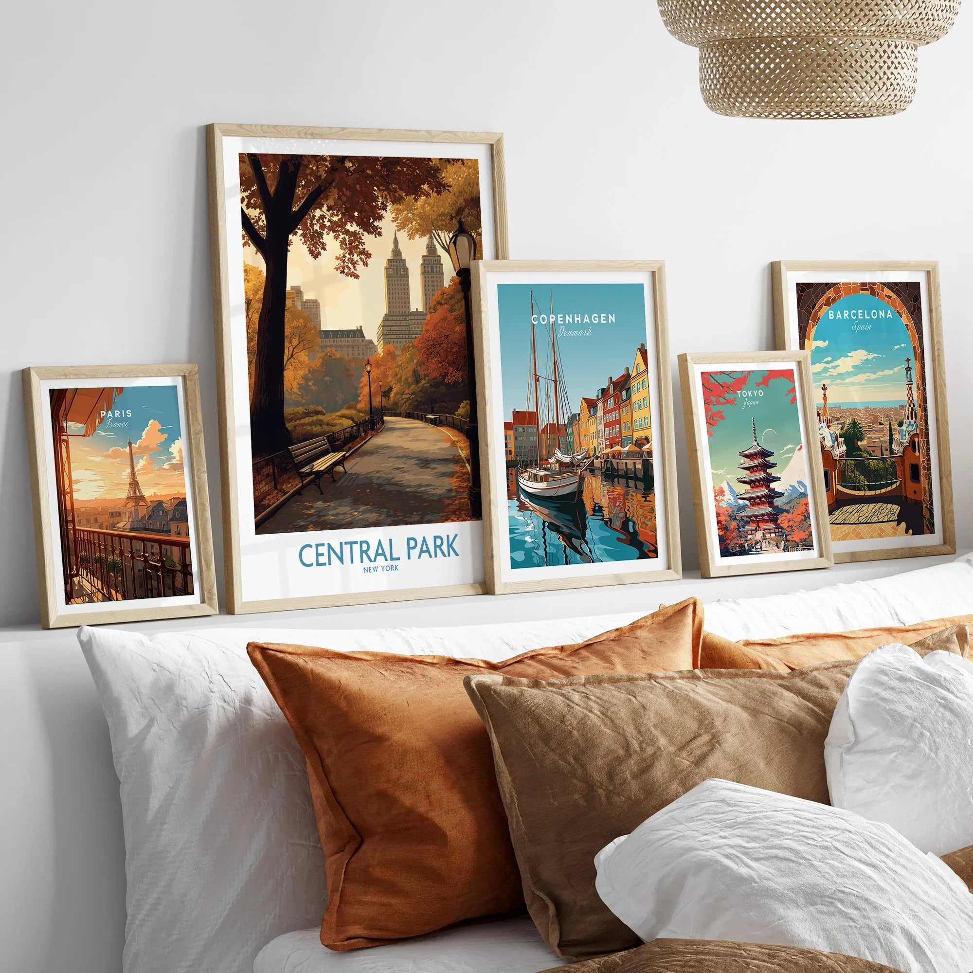 Set of five framed travel posters above bed, featuring Central Park, Paris, Copenhagen, Tokyo, Barcelona.
