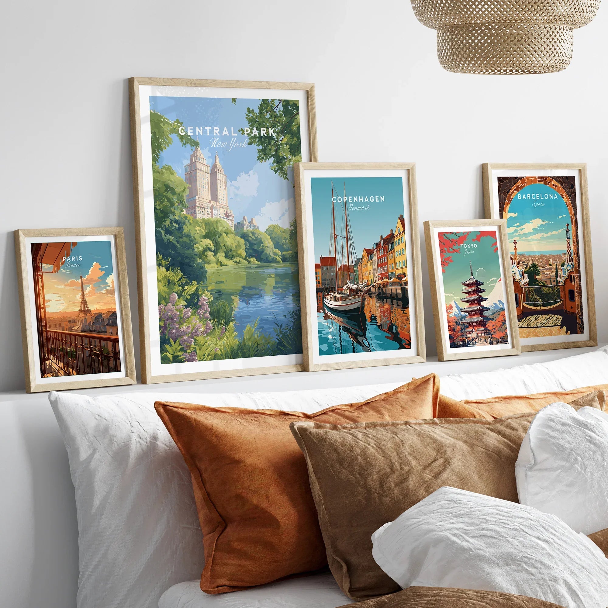 Set of five framed travel posters above bed, featuring Central Park, Paris, Copenhagen, Tokyo, Barcelona.