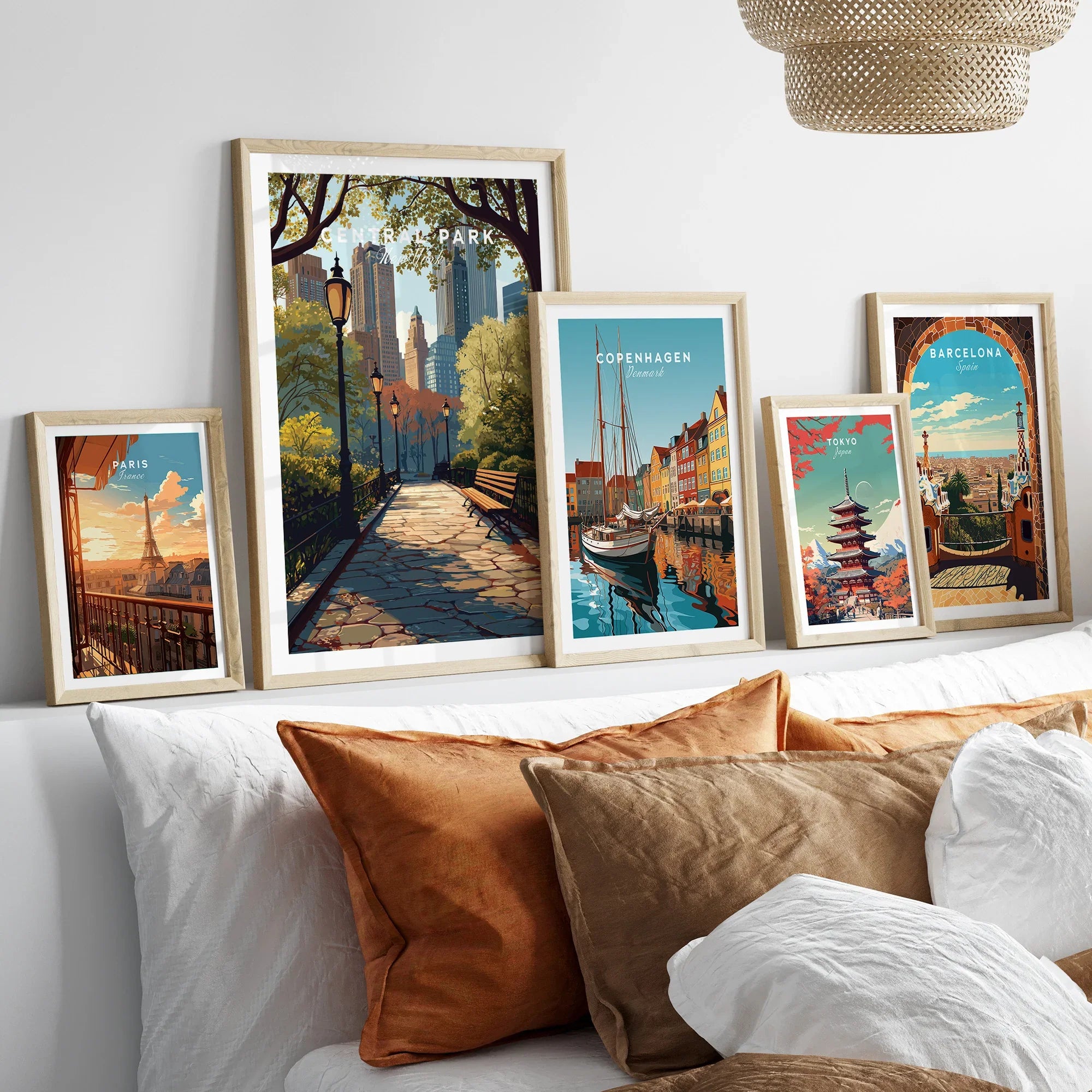 Framed travel art prints of Central Park, Paris, Copenhagen, Tokyo, and Barcelona above bed