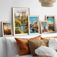Set of five framed travel posters above bed, featuring Paris, New York, Copenhagen, Tokyo, Barcelona.